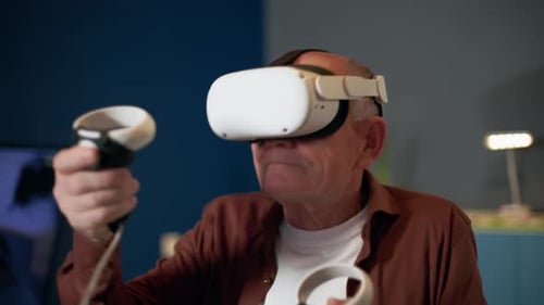 Senior Man Playing With Virtual Reality Headset