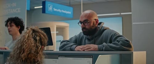 Airport Checkin Counter Woman Giving Documents and Airplane Ticket to Female Airline Agent
