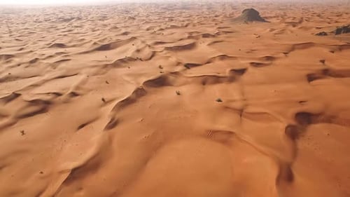 Golden Sand Dunes Stretching Across the Desert in Breathtaking Aerial Shot