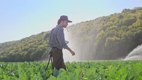 Farmer Using Digital Tablet During Monitoring His Plantation