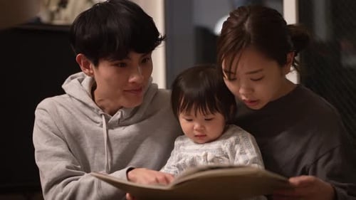 Family Reading Book Together Indoors