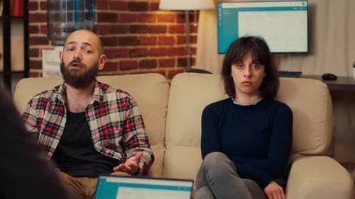 Couple Sitting on Couch Talking in Therapy Session