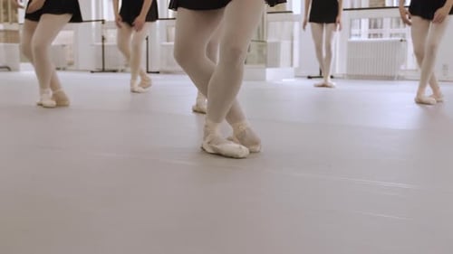 A group of young ballerina's training in a dance studio. Real time footage, close-up of their pointe