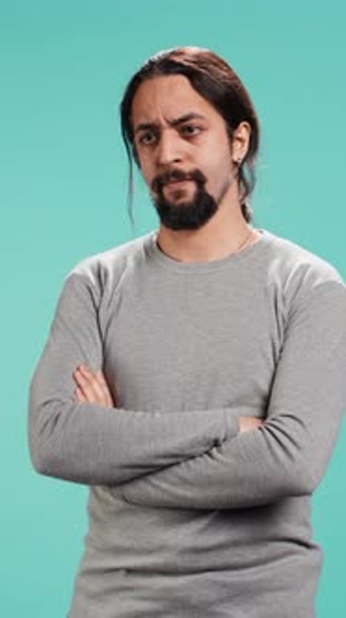 Man with Long Hair and Arms Crossed