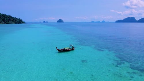 Koh Kradan Island Southern Thailand with Longtail Boats at the Beach and a Turqouse Colored Ocean