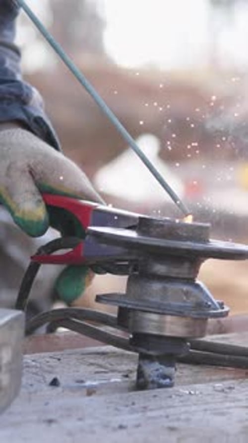 Closeup Fabricator Bending Metal Bracket With Pliers Hammer Mallet On Bench Tiny Sparks Precision