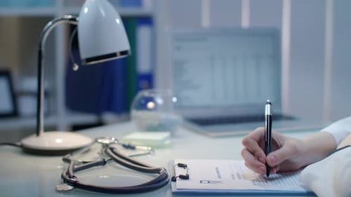 Female Doctor Hand Writing Medical Test Result. Close Up of Woman Doctor