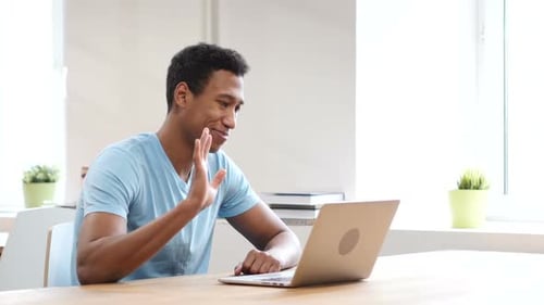 Young Adult Video Conferencing on Laptop