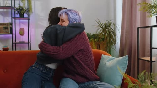Affectionate Couple Embracing on Couch at Home