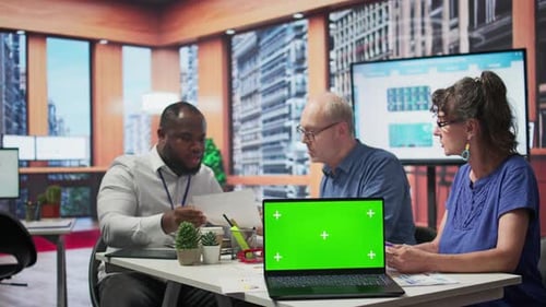 Old Couple Explore Financial Retirement Option with Advisor Next to Green Screen