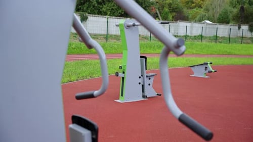Gym Equipment Installed on Red Rubberized Sports Surface