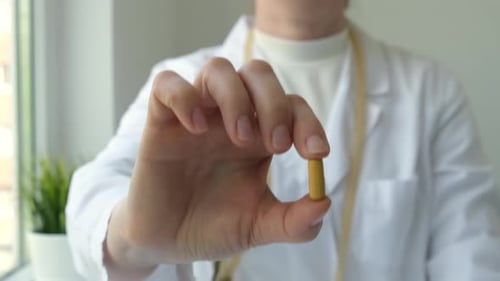 Doctor Showing Pill in Clinic Healthcare and Medicine