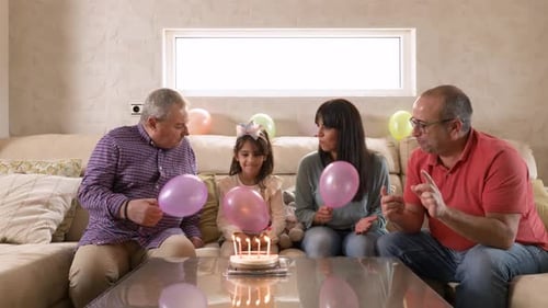 Family Celebrating a Birthday Together with Balloons