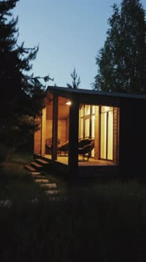 Modern Cabin Exterior at Night in Rural Setting