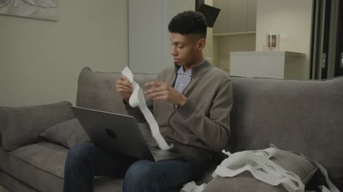 Man Shocked With His Expenses Millennial Man Accounting Domestic Finances Sitting on Couch