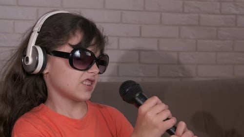 Child Singing with Microphone and Headphones Indoors