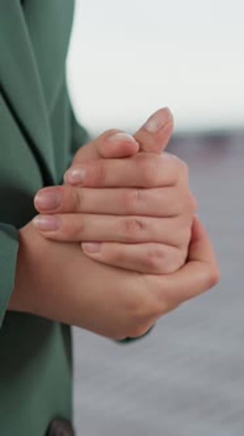 Close up of hands rubbing together in the city