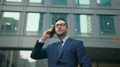 French Businessman Talking On Phone Outside Its Office Building In Seoul, South Korea. - low angle s