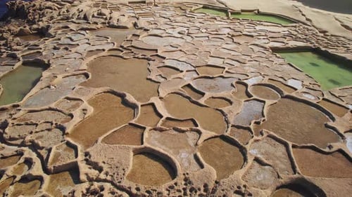 Reverse Dolly, Low Aerial of Salt Pans on Coast of Gozo Island, Malta