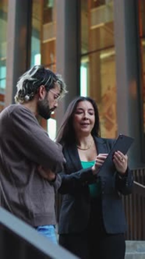 Business Meeting with Tablet Outside Modern Building