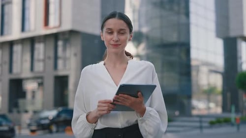 Young Adult Woman with Tablet in Urban Setting