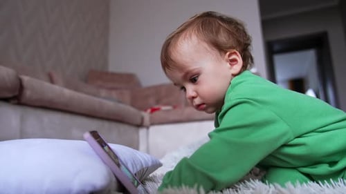 Toddler Using Smartphone on Pillow Indoors