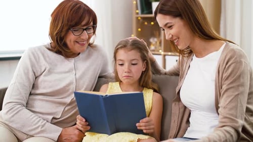 Grandmother Mother and Daughter Reading a Book Together