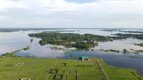 Aerial view of flooded land area submerged in flood water in Bangladesh. Drone fly forward shot