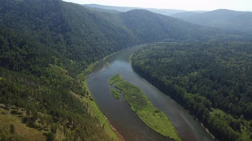 Awesome aerial view of scenic river among evergreen woods