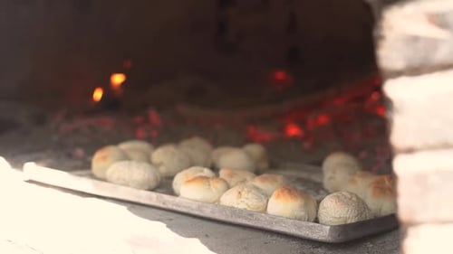 Cooking bread in clay oven traditional bakery of pastry in slow motion