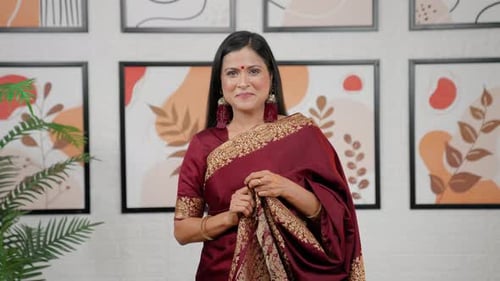 Woman Posing in Beautiful Maroon and Gold Saree