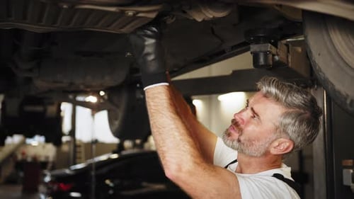 Close Up of Confident Professional Handsome Mature Male Mechanic Repairing the