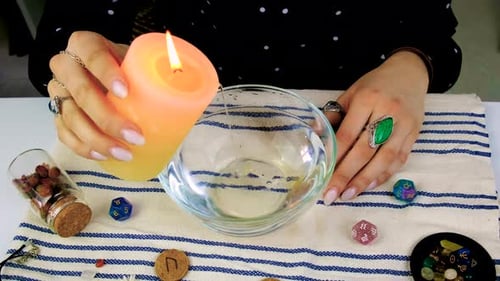 Woman performing a candle wax reading ritual