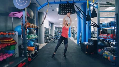 Full-length portrait of sportswoman in gym.