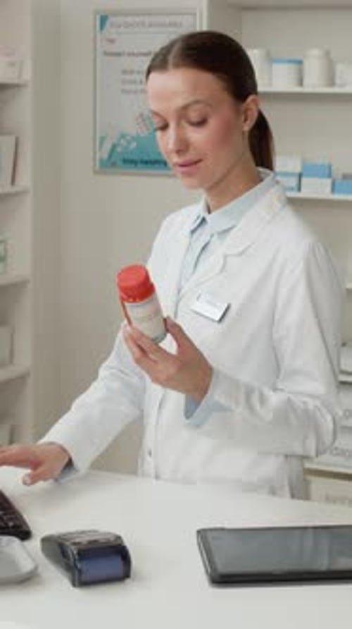 Female Pharmacist using PC Vertical