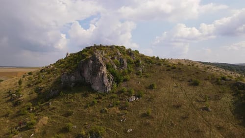 Aerial View on the Rocky Hill Drone Flies Forwards and Up Over Stony Landscape