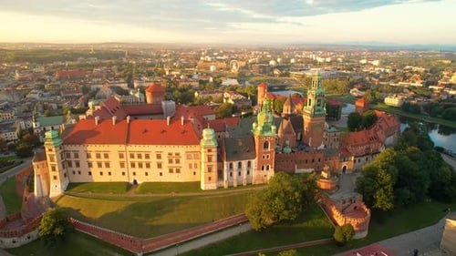 Aerial view Cracow old town green domed cathedral towers Wawel castle Poland pull away shot