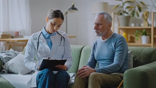 Doctor Consulting with Senior Patient at Home