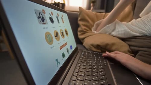 Woman shopping online on laptop at home