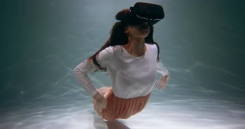 Futuristic Cinematic View of Virtual Reality Happy Mixed Race Woman in VR Headset Swimming Deep