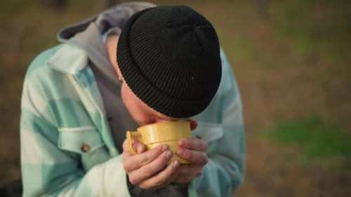 Wanderer in Woods Experiencing Peaceful Sunrise and Thoughtful Moment Young Explorer in Forest