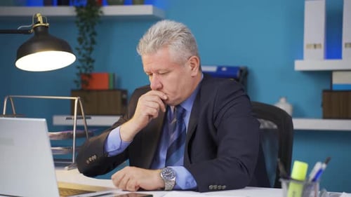 Exhausted Man Working in Office During Day