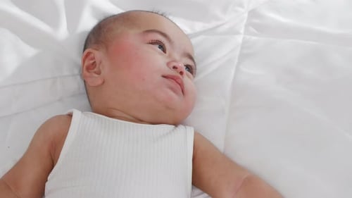 Asian Cute Little Baby on Bed Under Soft Blanket