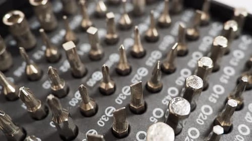 Rotating Universal screwdriver set with different bits. Close-up bit set.