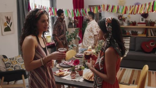 Two Women Chatting at an Indoor Casual Party