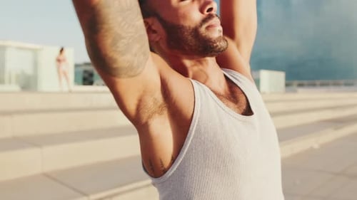 Close up, young athlete doing workout, stretching on the embankment