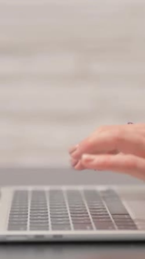 Side View of Hands Typing on Laptop, vertical video