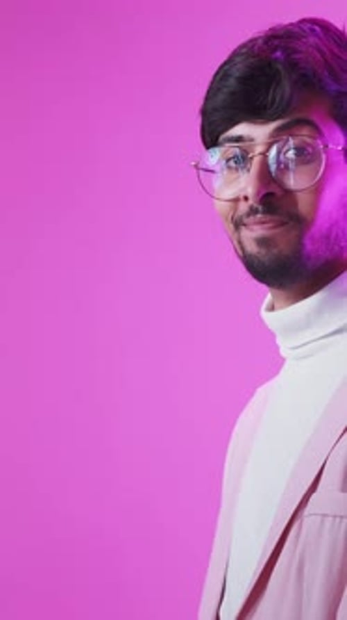 Adult Smiling and Presenting in Pink Studio