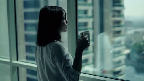 Young Businesswoman Drinking Coffee and Admire View From Window in Office 30s