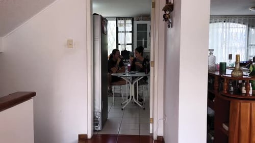 Young Adults Sharing a Meal in Kitchen